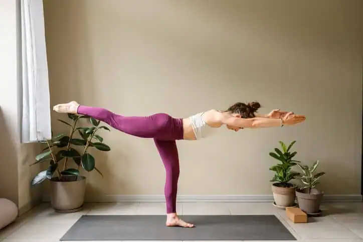 Woman doing Yoga exercise Hatfield to help with toning the body. 